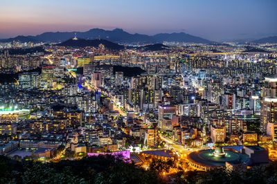 Aerial view of illuminated city buildings at night