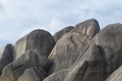 Low angle view of rock formations against sky