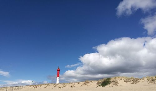 Scenic view of beach against blue sky