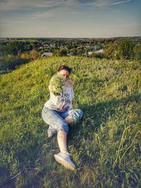 Full length of man sitting on field