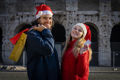 A young couple just bought some christmas presents. 