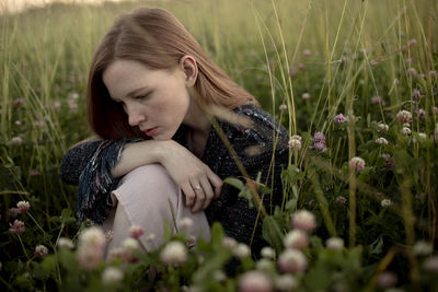 Woman with flowers on field