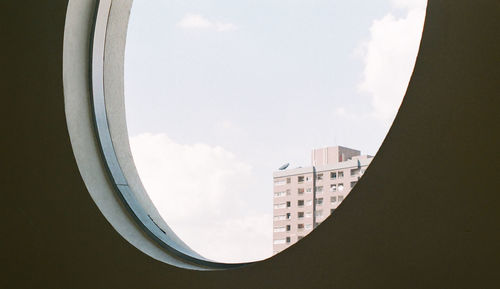 Low angle view of buildings in town against sky