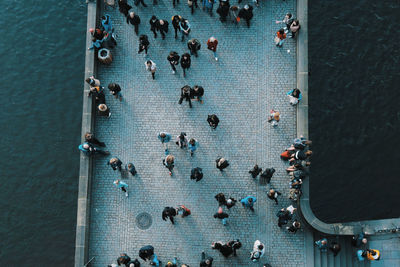 Directly above shot of people on bridge over sea