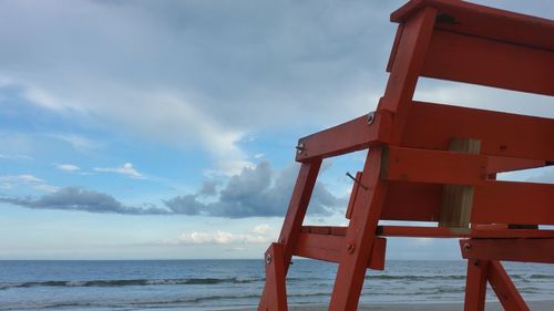 Lifeguard hut on beach against sky