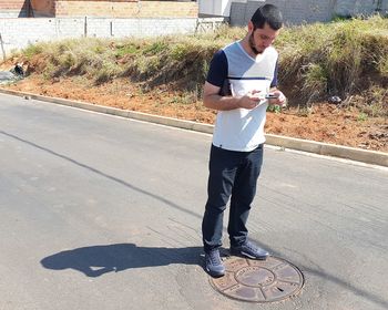 Full length of a man standing on road