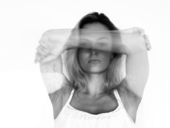 Close-up of young woman against white background