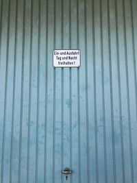 Information sign against wall