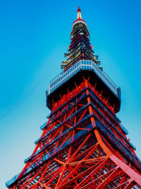 Low angle view of tokyo tower against clear blue sky