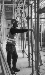 Side view of young man standing at construction site