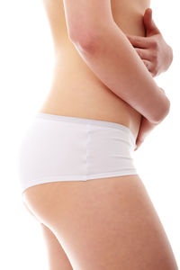 Midsection of woman standing against white background