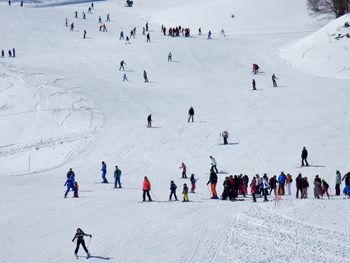 High angle view of people enjoying in snow