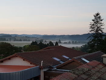 High angle view of houses and trees against sky