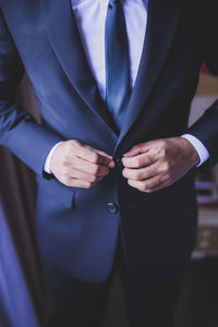 Midsection of man holding umbrella