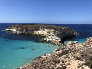 Scenic view of sea against clear blue sky