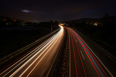 Many light trails in night of cars and trucks motorway