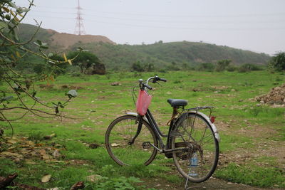 Bicycle on field against sky