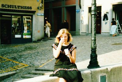 Woman sitting on the road