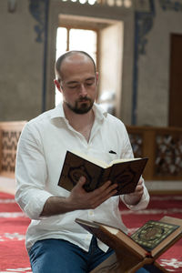 Man reading koran in mosque