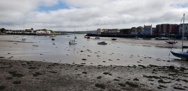 Boats moored in sea against sky