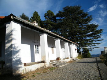 Low angle view of building and trees against sky