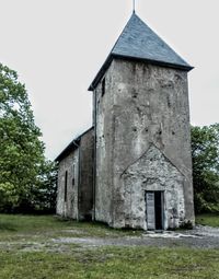 Old house on field against sky