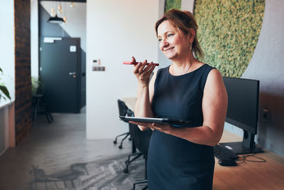 Businesswoman having business video call on laptop in office. mature busy woman working remotely