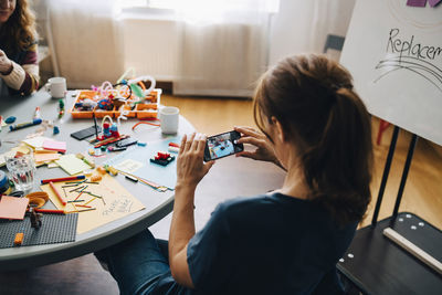 Woman using mobile phone at home