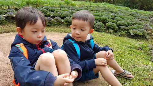 Brothers sitting at park