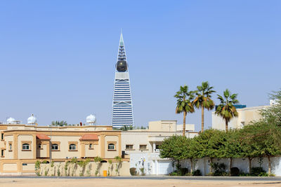 Buildings in city against clear sky