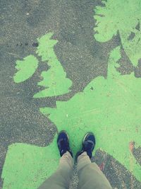 Low section of man standing on footpath