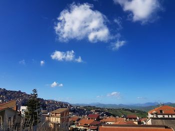 High angle view of townscape against blue sky