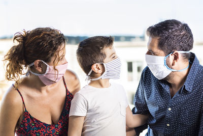 Happy family with protective masks