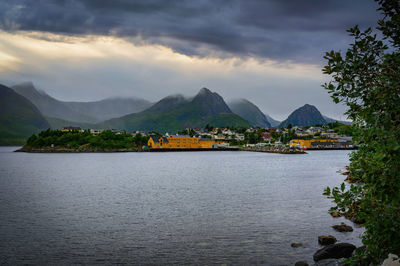 Scenic view of sea and mountains against sky