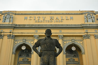 Low angle view of statue against building