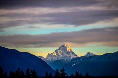 Scenic view of snowcapped mountains against dramatic sky