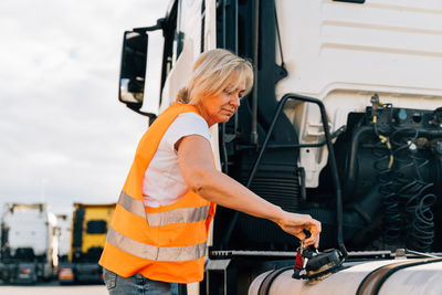 Driver opening tank of truck