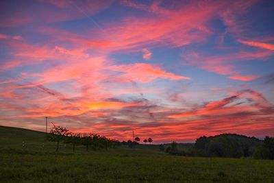Scenic view of field against sky during sunset