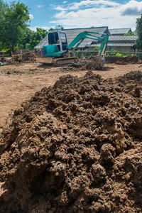 Construction site by road against sky