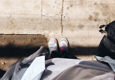 Low section of person standing on footpath