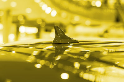 Antena shark fin on roof car. view from the side. yellow tinted color . selective focus.