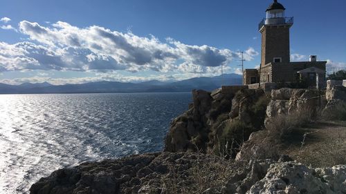 Sea by buildings against sky