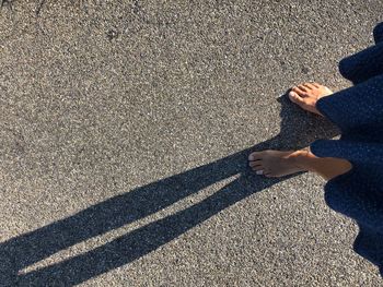 Low section of person standing on road