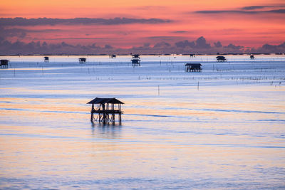 Beautiful fishing huts in sunrise light of red color sky where a fisherman's life start at dawn 