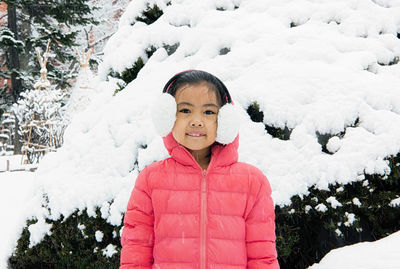 Portrait of girl standing in snow