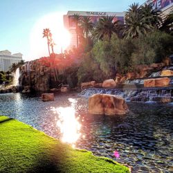 Scenic view of waterfall against sky during sunset