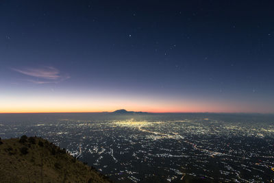 Aerial view of cityscape against sky at night