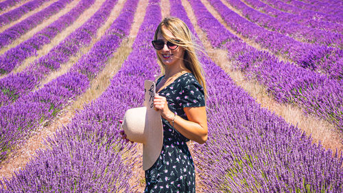 Close up of a young girl with a hat between lavender in southern provence valensole 