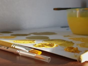 Close-up of paintbrush and paint on table