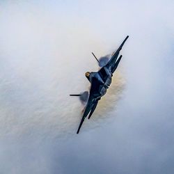 Low angle view of airplane flying in sky